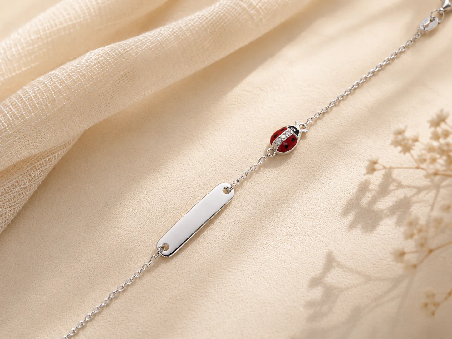 Silver ID bracelet with red ladybug charm