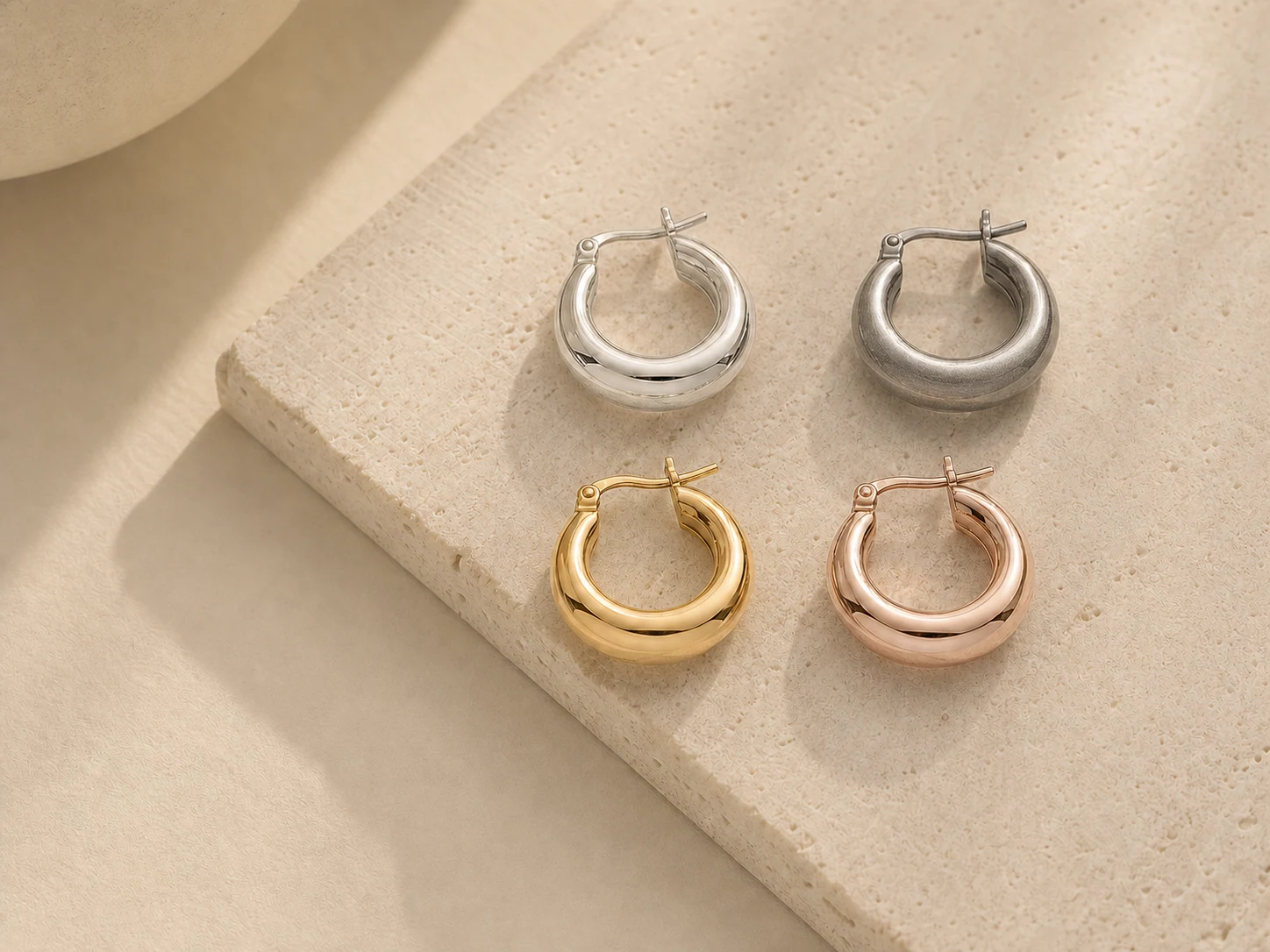Sterling silver jewelry finish samples in polished silver, antique silver, gold and rose gold plating