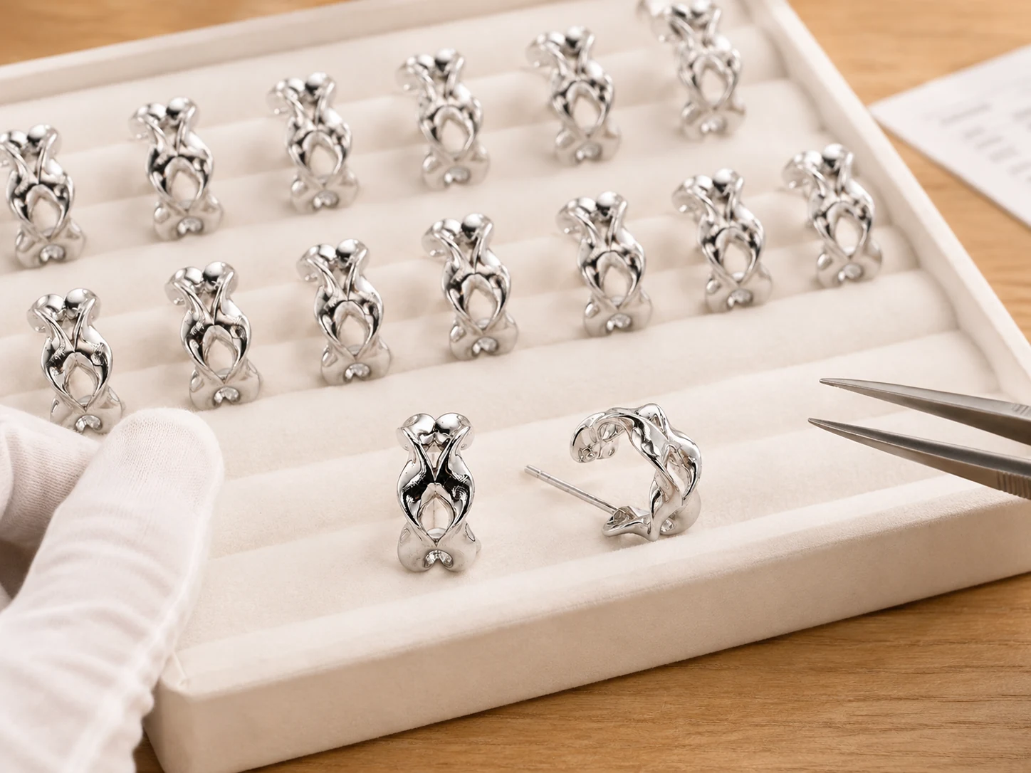Batch inspection of matching silver stud earrings