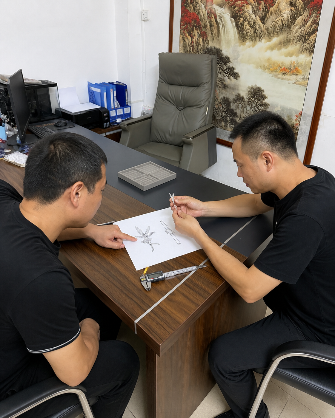 Elisen Silver team reviewing a custom pendant drawing and sample